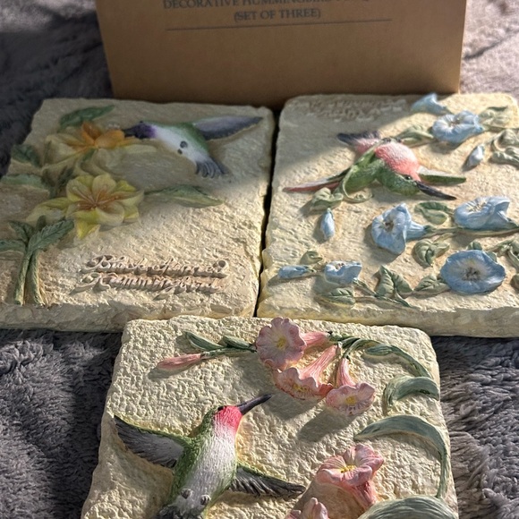 This is a set of three vintage Avon decorative hummingbird plaques